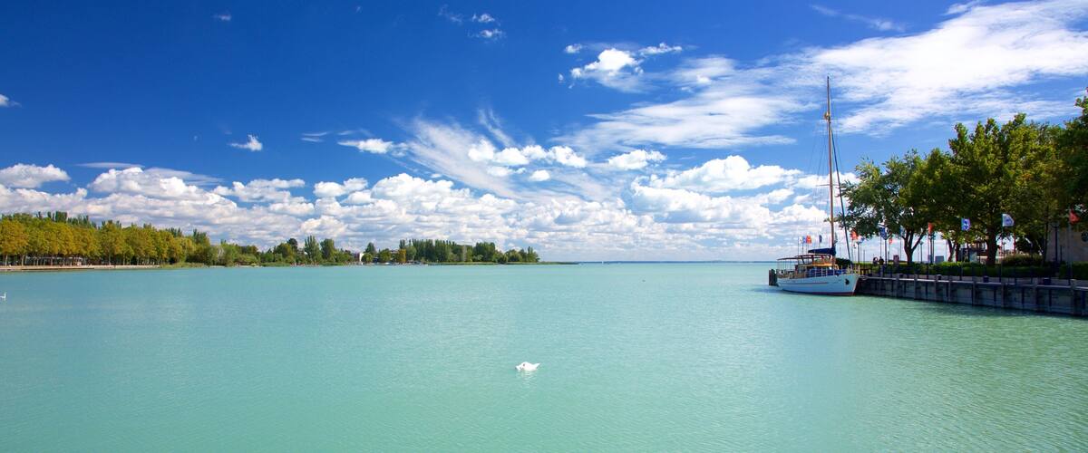 Balatonfured which includes general coastal views and a bay or harbor