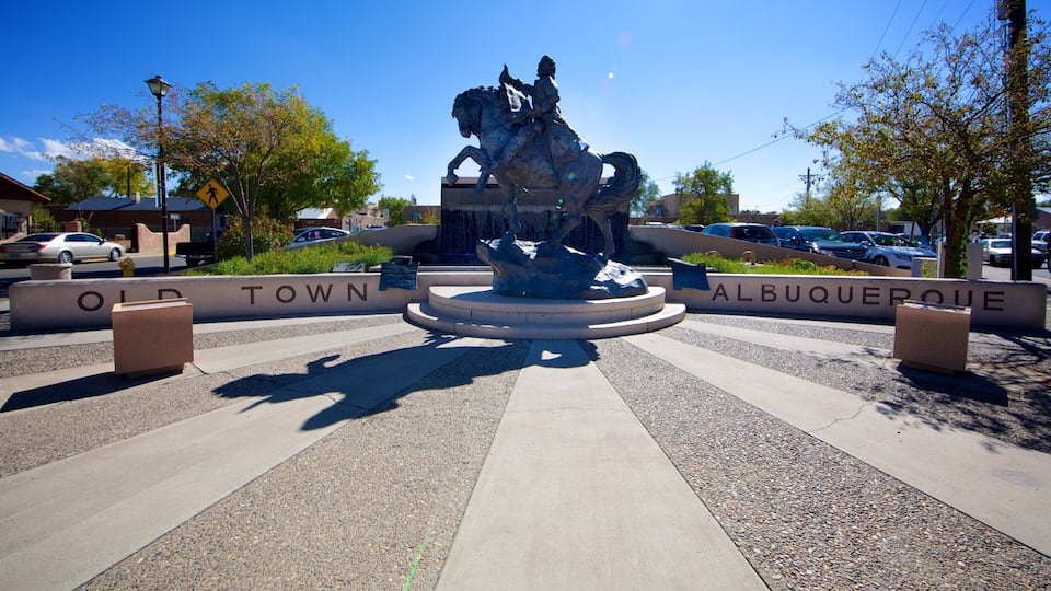 A statue of a man on horseback in a plaza with 'OLD TOWN' and 'ALBUQUERQUE' signs.