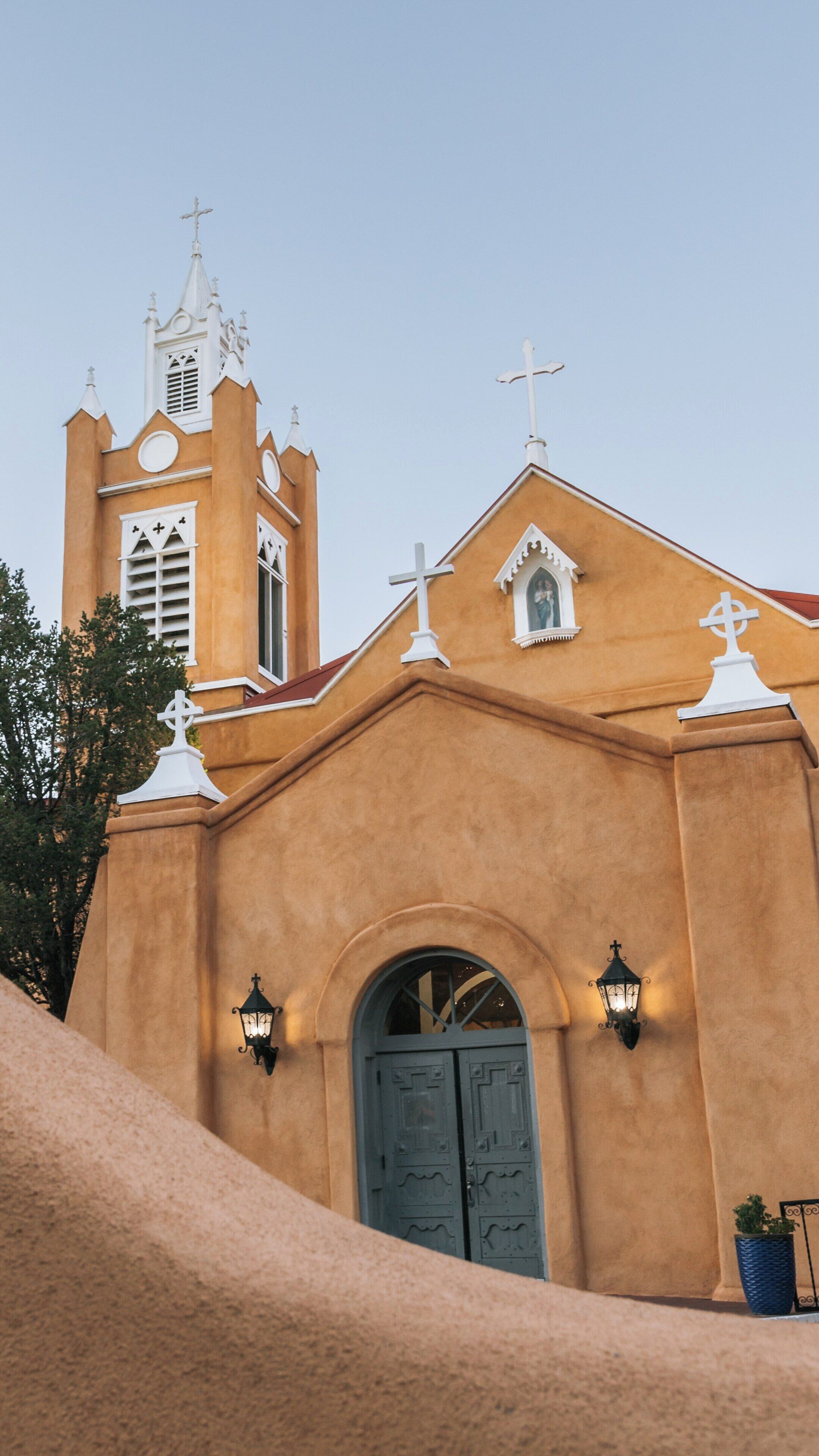 Historic San Felipe de Neri Church stands in Old Town Albuquerque, showcasing its adobe architecture and beautiful evening light in New Mexico
