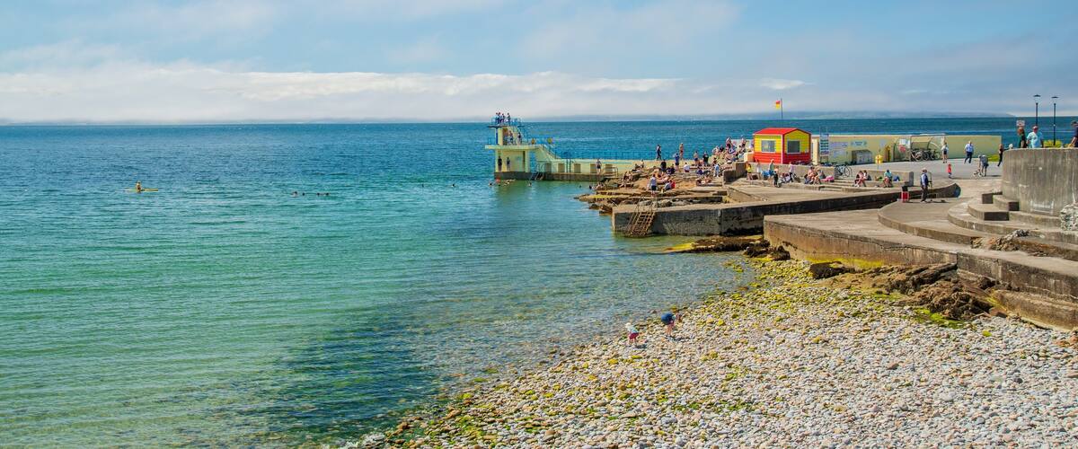 Salthill which includes a pebble beach, swimming and general coastal views