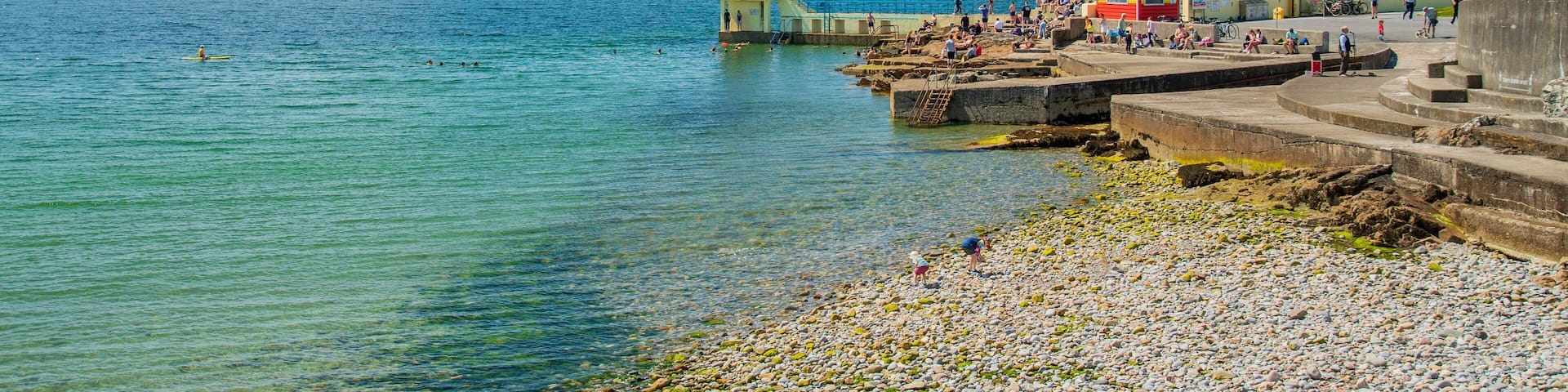 Salthill which includes a pebble beach, swimming and general coastal views