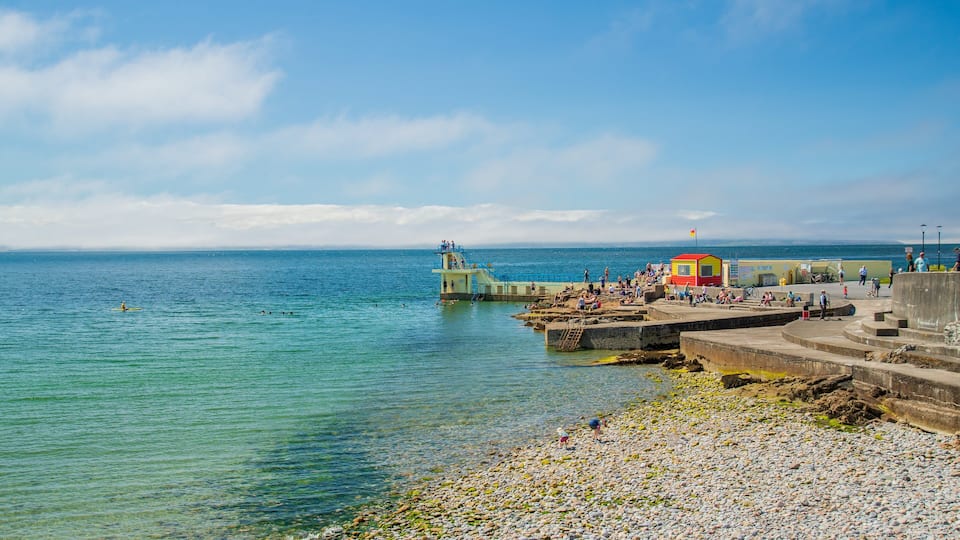 Salthill which includes a pebble beach, swimming and general coastal views