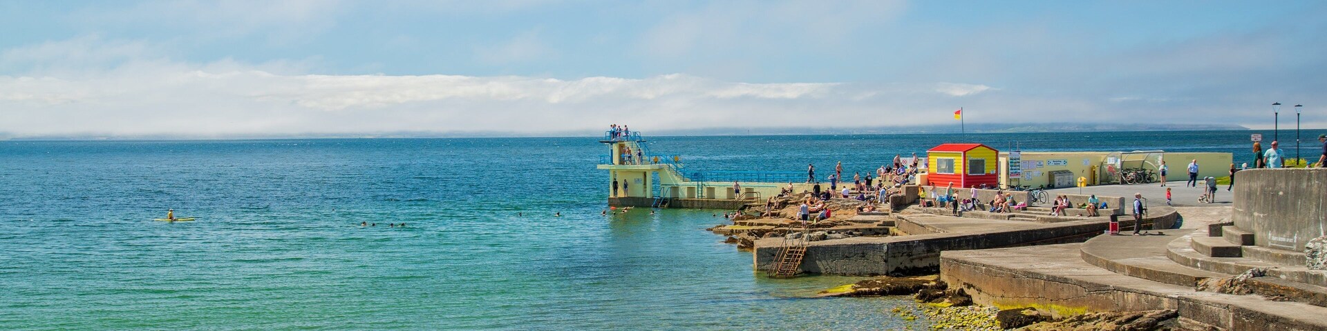 Salthill which includes a pebble beach, swimming and general coastal views
