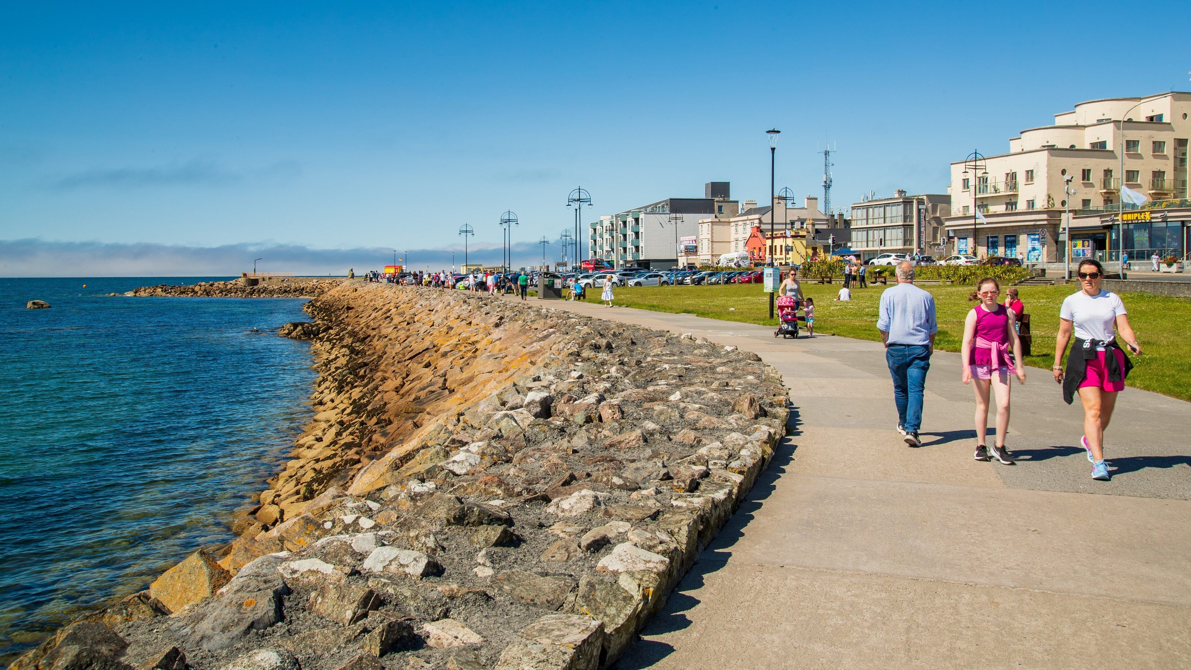 Salthill featuring general coastal views and street scenes as well as a family
