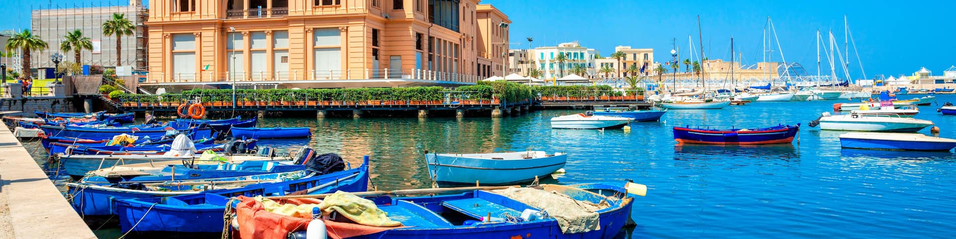 Margherita Theater and fishing boats in old harbor of Bari, Puglia, Italy. Bari is the capital city of the Metropolitan City of Bari on the Adriatic Sea, Italy. Architecture and landmark of Italy