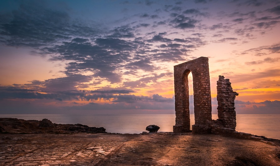 Sunset over the Sea and Rocky Coast with Ancient Ruins and Gate to Africa in Mahdia, Tunisia; Shutterstock ID 174741179