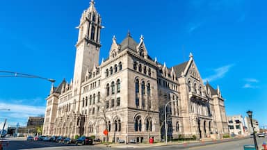 A large, historic building with intricate architecture and a tall tower.