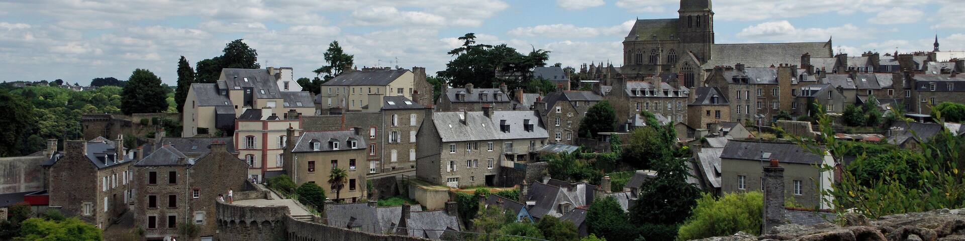 A historic town with a prominent church and castle ruins.