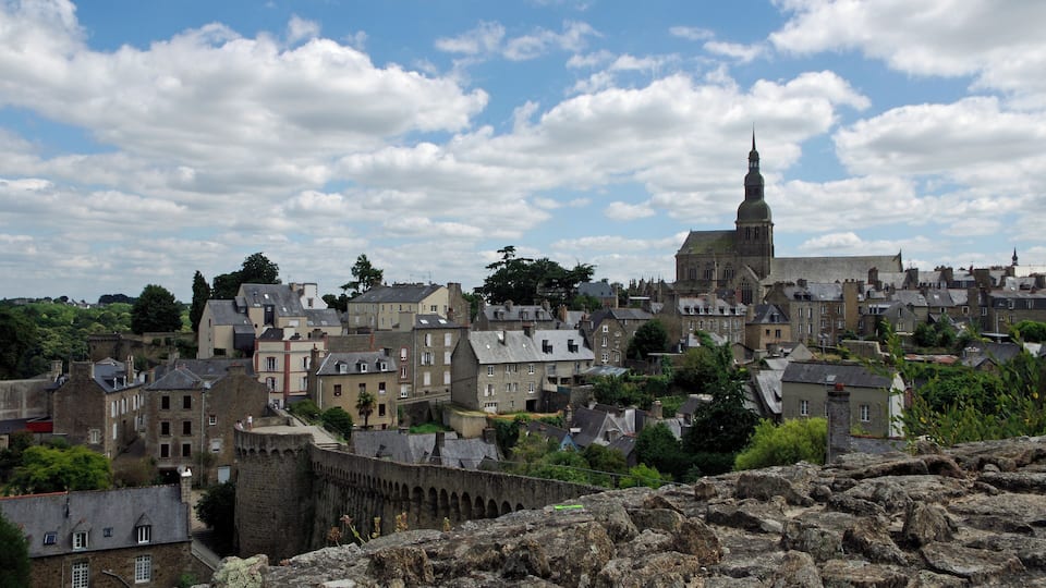 A historic town with a prominent church and castle ruins.