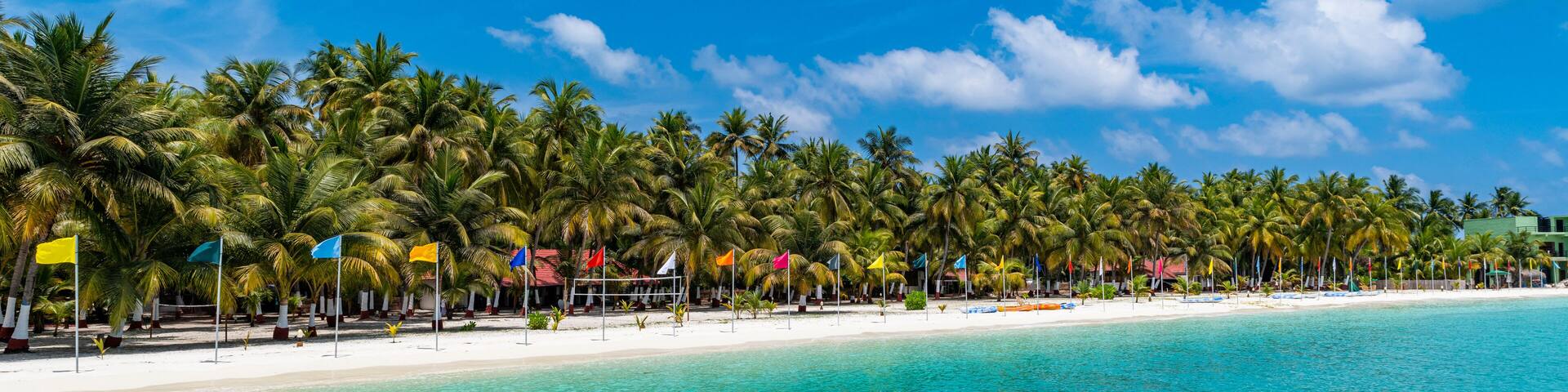 White sand beach with many flags, Bangaram island, Lakshadweep archipelago, Union territory of India, Indian Ocean, Asia