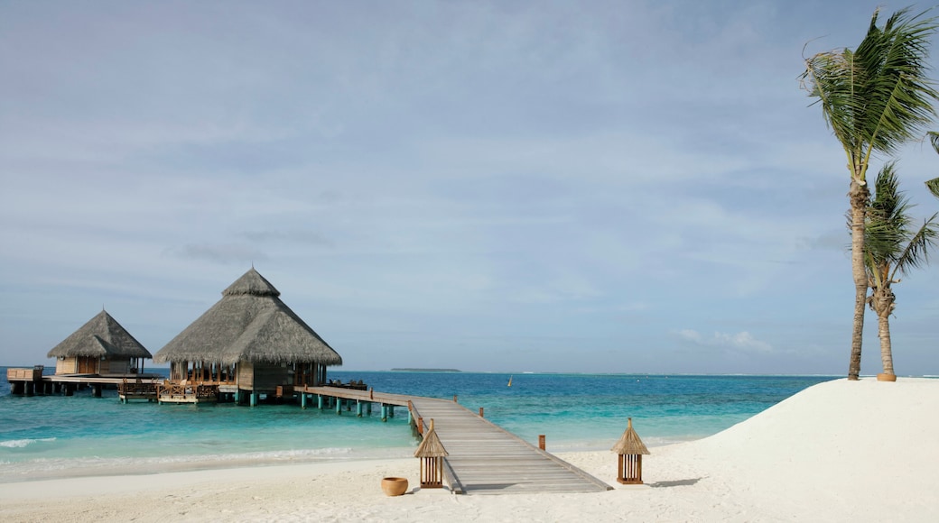 Boardwalk guiding to two bungalows in the ocean