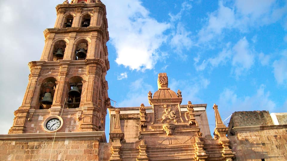 A historic church with a bell tower and a clock.