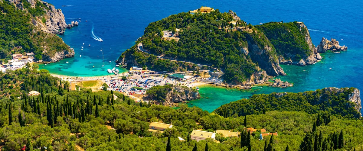 Panoramic view of Palaiokastritsa, boats and beach Corfu, Greece
