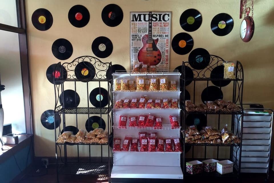 A display of snacks and a wall decorated with vinyl records.