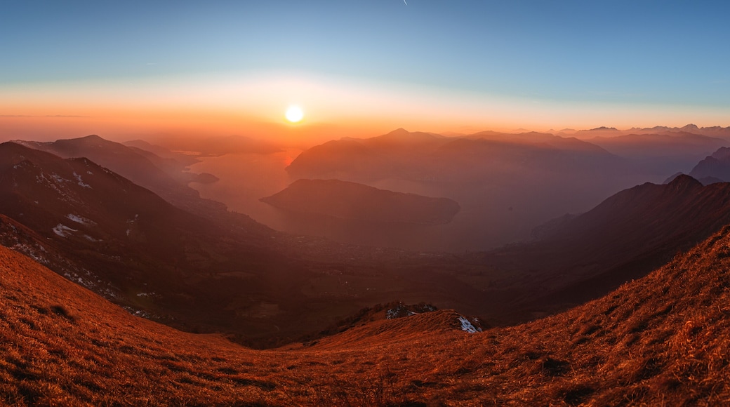 The Lombard pre-Alps near Lake Iseo, seen at sunset from one of the most beautiful viewpoints in the Province of Brescia: Punta Almana, near the town of Sale Marasino, Italy - February 2023.