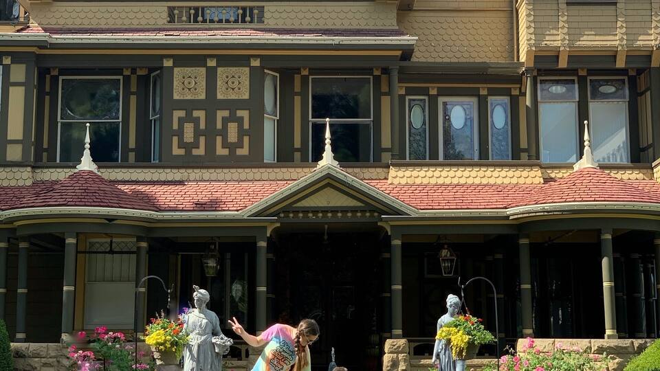 A historic building with a distinctive architectural style, featuring a central entrance with a decorative archway and a tiled roof.