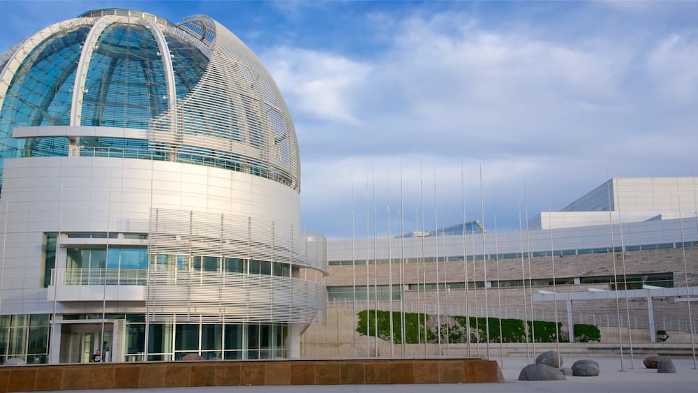 A modern architectural building with a large dome and a curved facade.