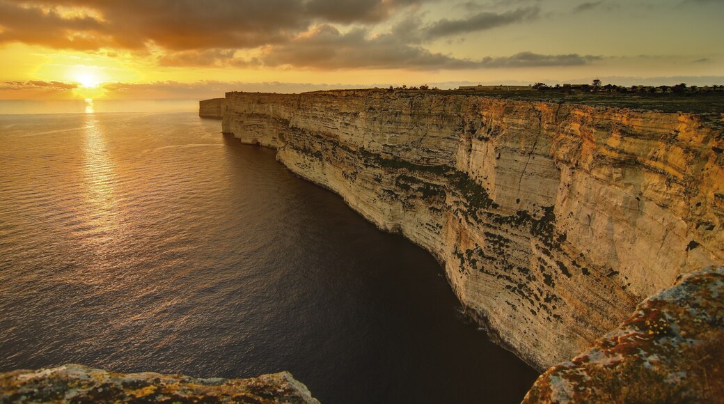 Gozo showing rugged coastline, a sunset and landscape views