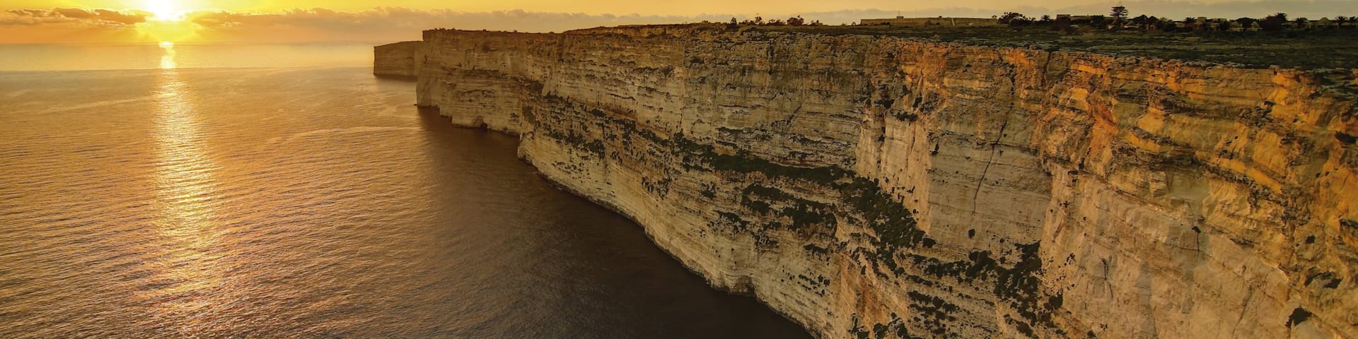 Gozo showing a sunset, rugged coastline and landscape views