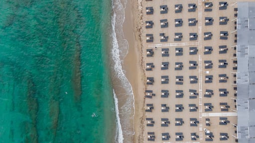 Aerial view of parasols on an empty beach in Fanari beach along the Thracian Sea, East Macedonia and Thrace, Greece.