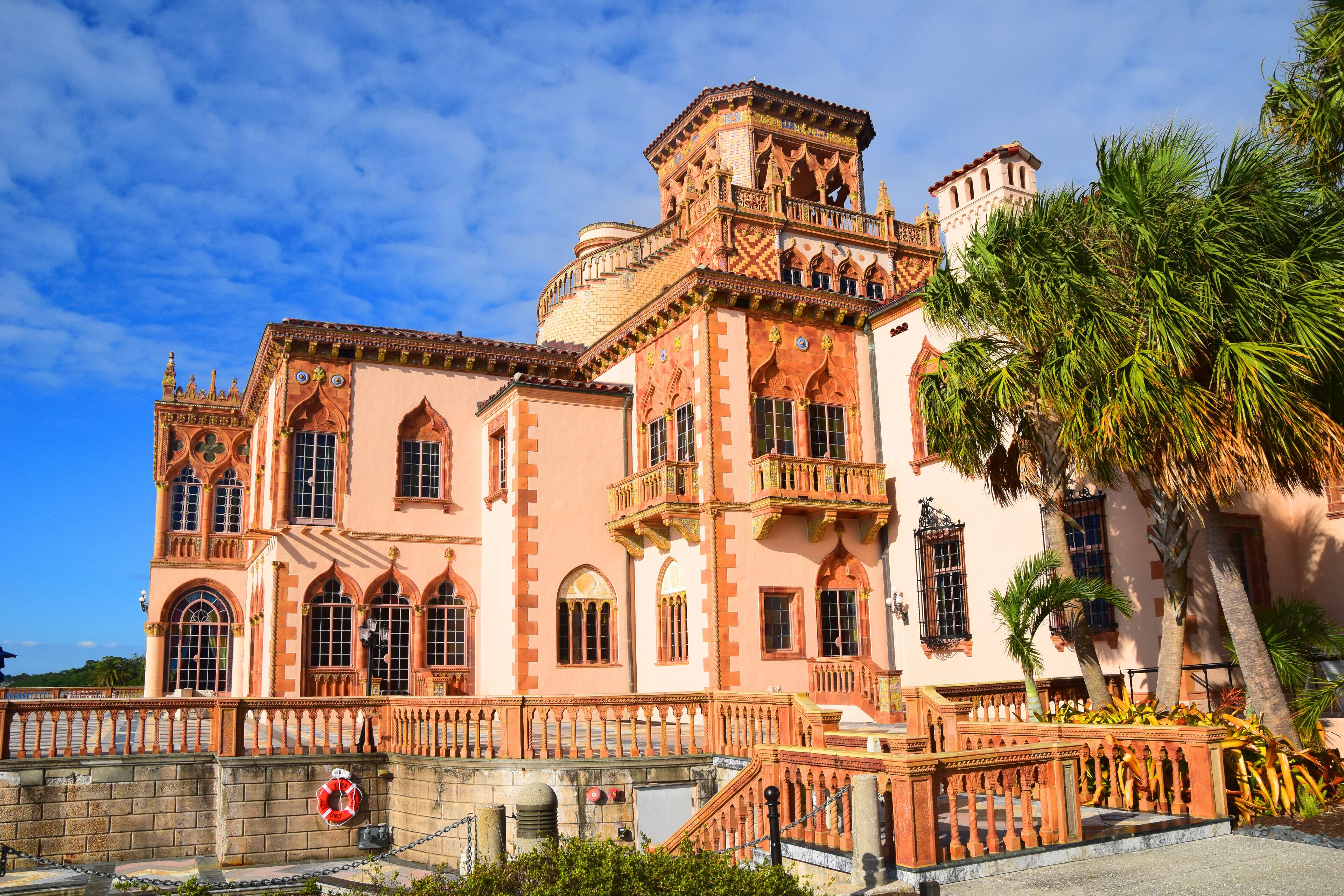 A large, ornate building with intricate architectural details and a prominent balcony.