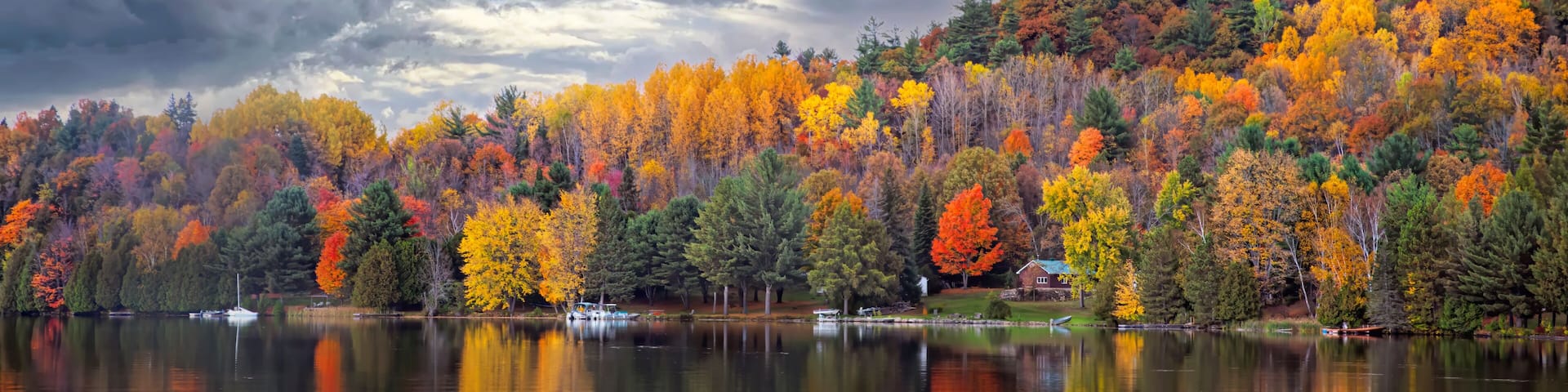 Fall colours along the Gatineau river reflected in water, Quebec, Canada