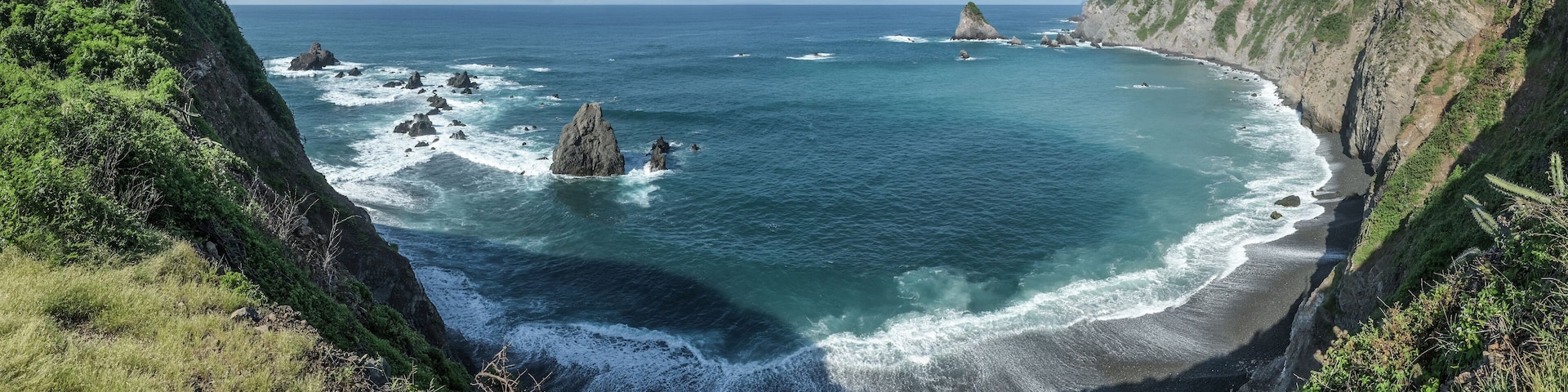 A coastal landscape with rocky outcrops and cliffs.