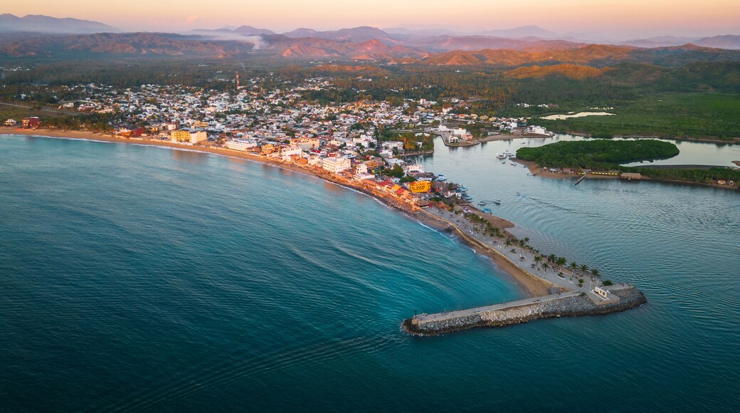 Barra de Navidad Aerial of Jalisco Mexico resort beach town with pacific coastline ocean view at sunset and lake lagoon