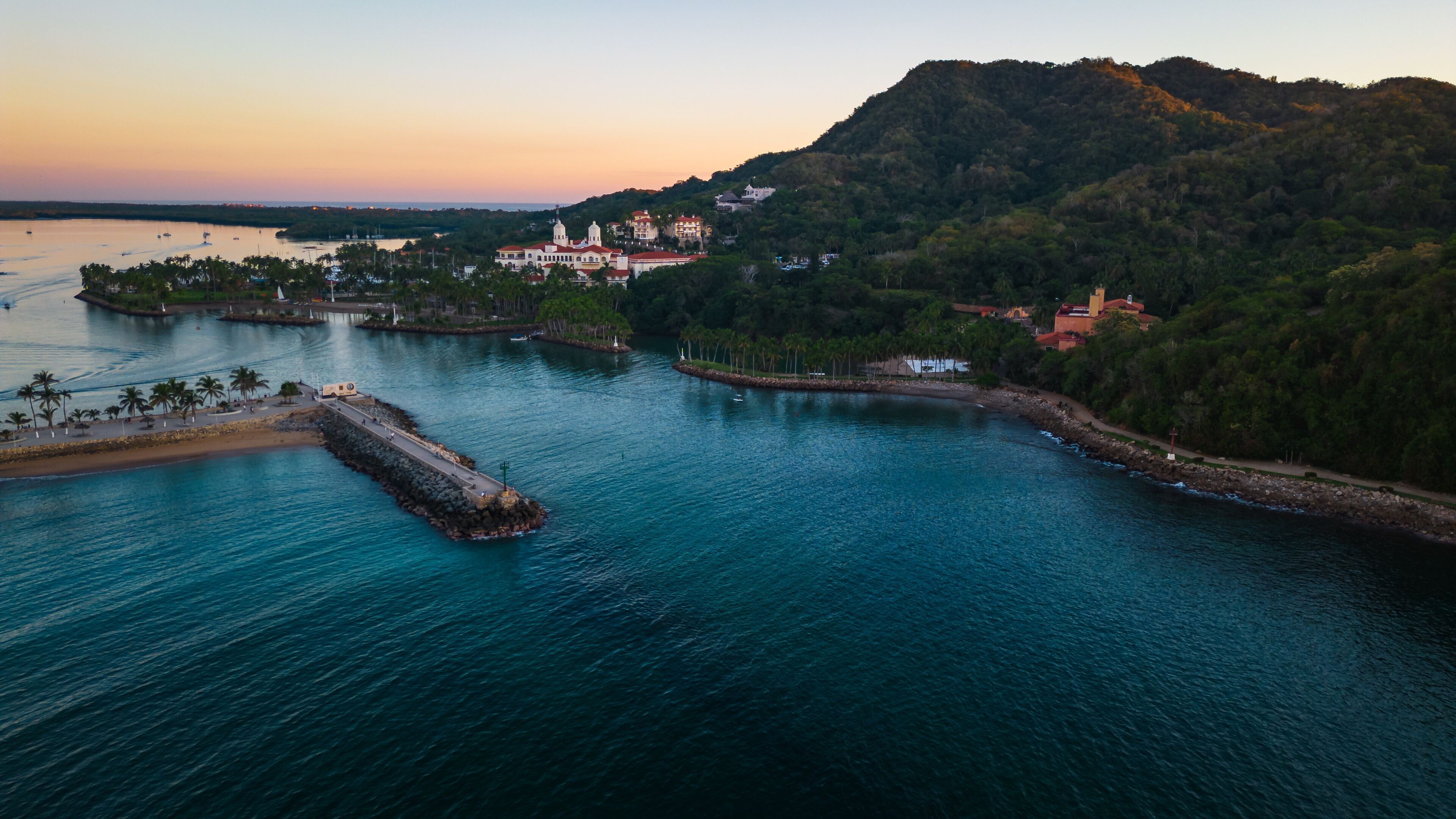 Barra de Navidad Aerial of Jalisco Mexico resort beach town with pacific coastline ocean view at sunset and lake lagoon