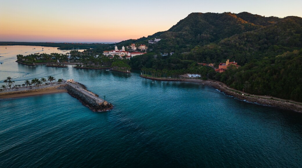 Barra de Navidad Aerial of Jalisco Mexico resort beach town with pacific coastline ocean view at sunset and lake lagoon