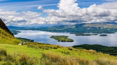 Hikers descending Conic Hill towards Loch Lomond with beautiful mountain scenery