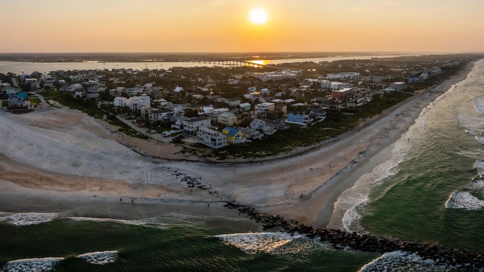 Aerial view of serene sunset over Vilano Beach shoreline, St. Augustine, Florida, United States.
