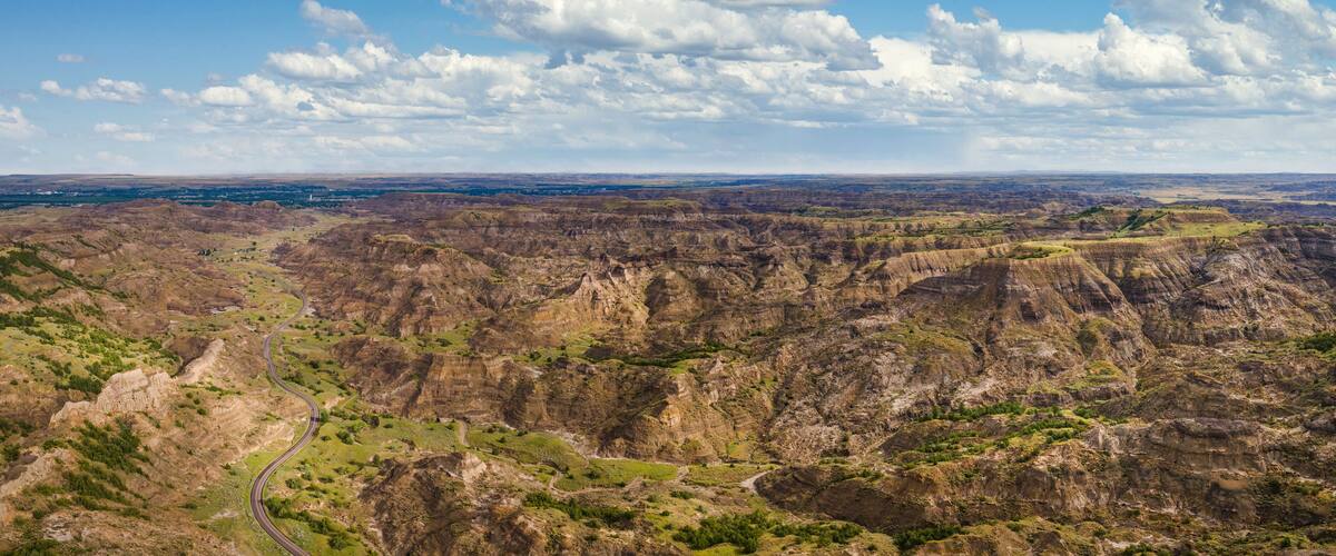 Aerial view of road into Makoshika State Park in Montana - Badlands