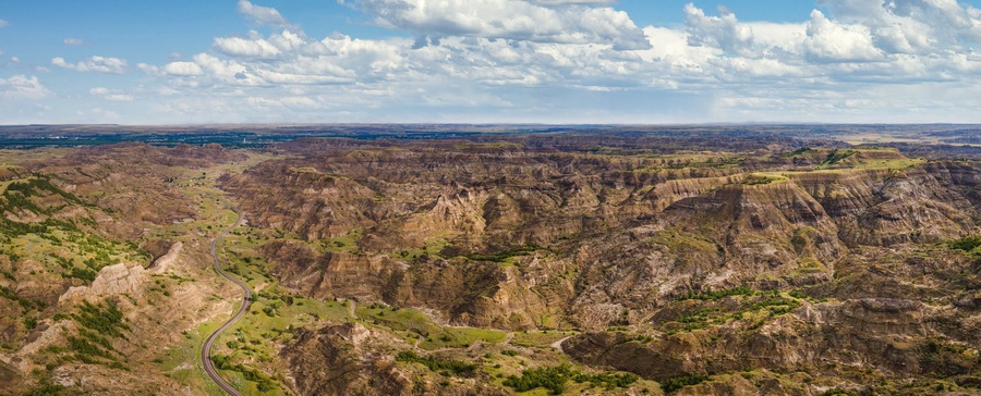 Aerial view of road into Makoshika State Park in Montana - Badlands