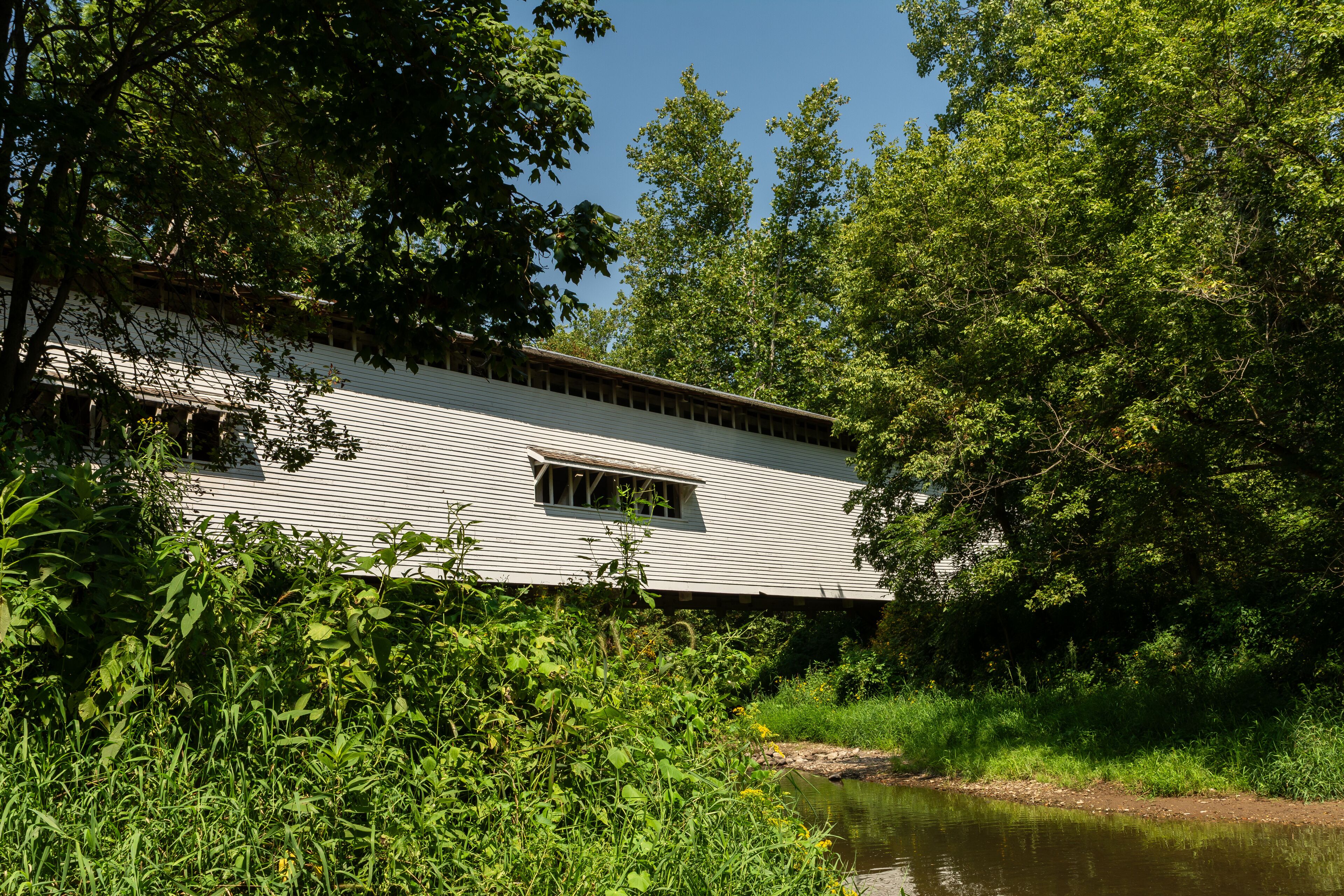 The Portland Mills covered bridge, built in 1858 by Henry Wolfe, spanning the Little Raccoon Creek .  Waveland, Indiana, USA
