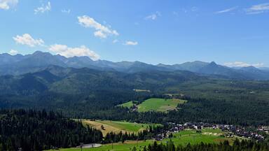 Majestic mountains peaks of High Tatra moutnains. High Tatras and Male Ciche ski resort seen from a metal observation tower with a modern glass terrace offering a stunning panorama at Poronin, Poland
