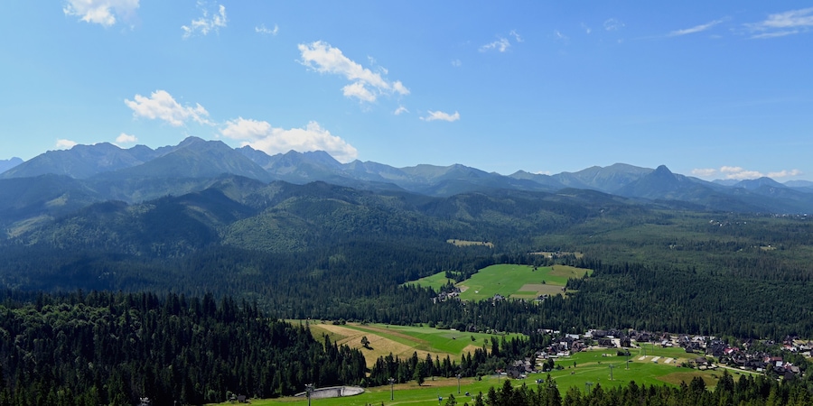 Majestic mountains peaks of High Tatra moutnains. High Tatras and Male Ciche ski resort seen from a metal observation tower with a modern glass terrace offering a stunning panorama at Poronin, Poland