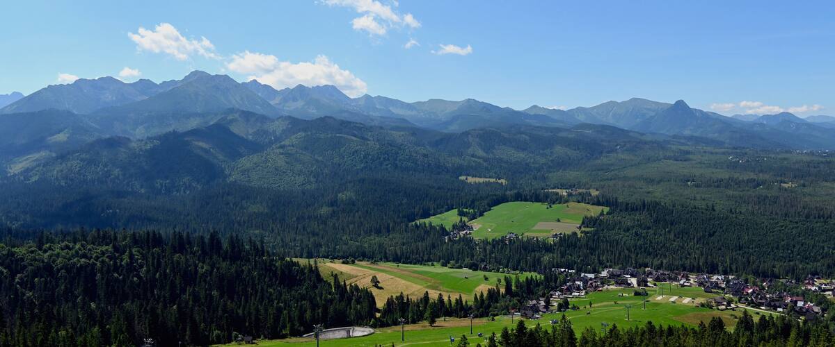 A mountainous landscape with a village nestled in a valley.