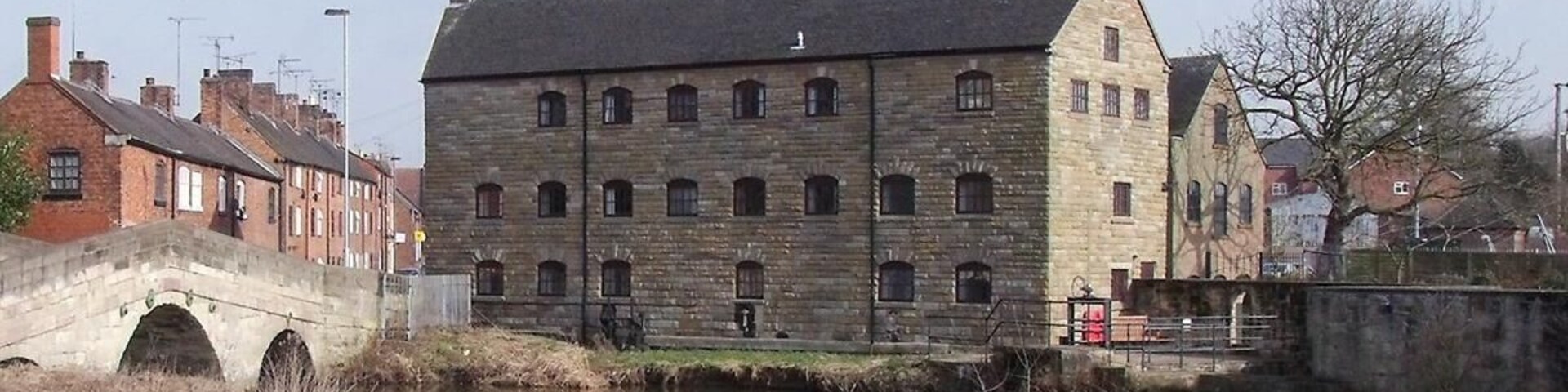 Rocester Corn Mill There has been a corn mill on the Churnet at Rocester for centuries. This mill was originally powered by an undershot wheel, on the right-hand side where the sluices now are. The wheel has now been replaced by a 58kW turbine for generating electricity and the building is now the offices of JCB Finance.