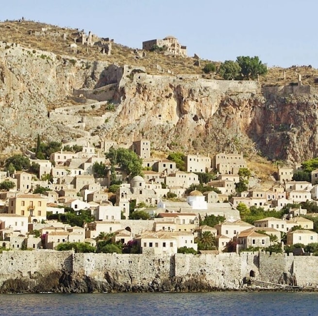 The fortified town of Monemvasia sits upon a rocky peninsula off the east coast of the Peloponnese. Though the 300ft (100m) cliffs proved difficult to conquer, it's strategic position made it a pawn during treaty negotiations.
The lower town and cliff-top fortress were founded in the 6th century and initially served as a refuge during the Slavic and Avaric invasion of Greece. Later, the fortress withstood Arab and Norman invasions in 1147, but finally fell to Achaea after a three year siege in 1248. Over the next few hundred years it was ruled by the Byzantine Empire, then the Vatican, the Venetians, the Ottomans and finally the Greeks.
Today, the lower town has become a quaint tourist village while the upper fortress lies largely in ruins. It's worth the climb up though just to wander the walls and enjoy the views. Watch your step though - you don't want to fall into an ancient cistern!
Monemvasia is a worthy overnight stay. If you aren't up for driving, hop a 4 hour ferry from Athens.