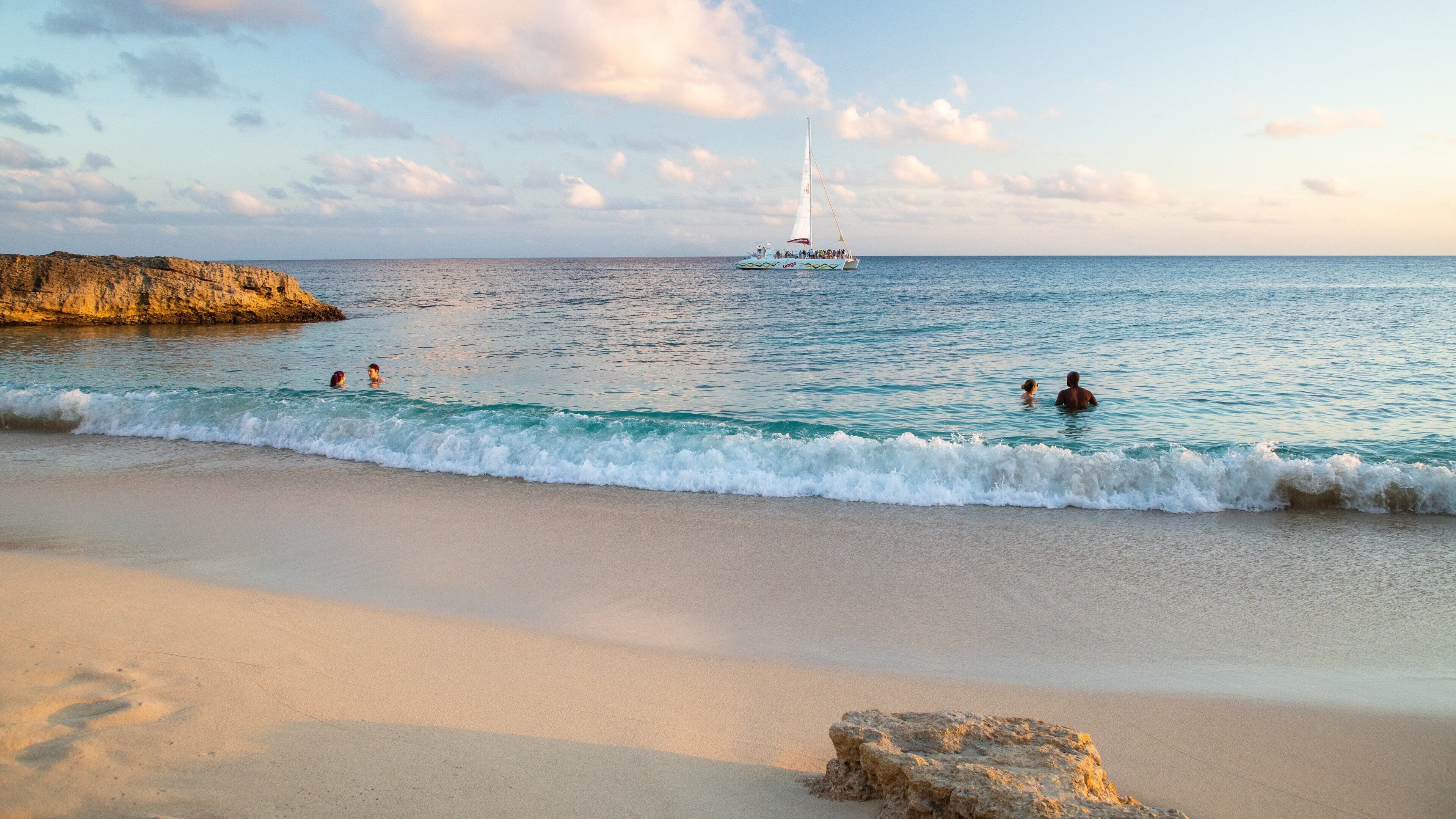 Cupecoy featuring swimming, a sunset and a sandy beach