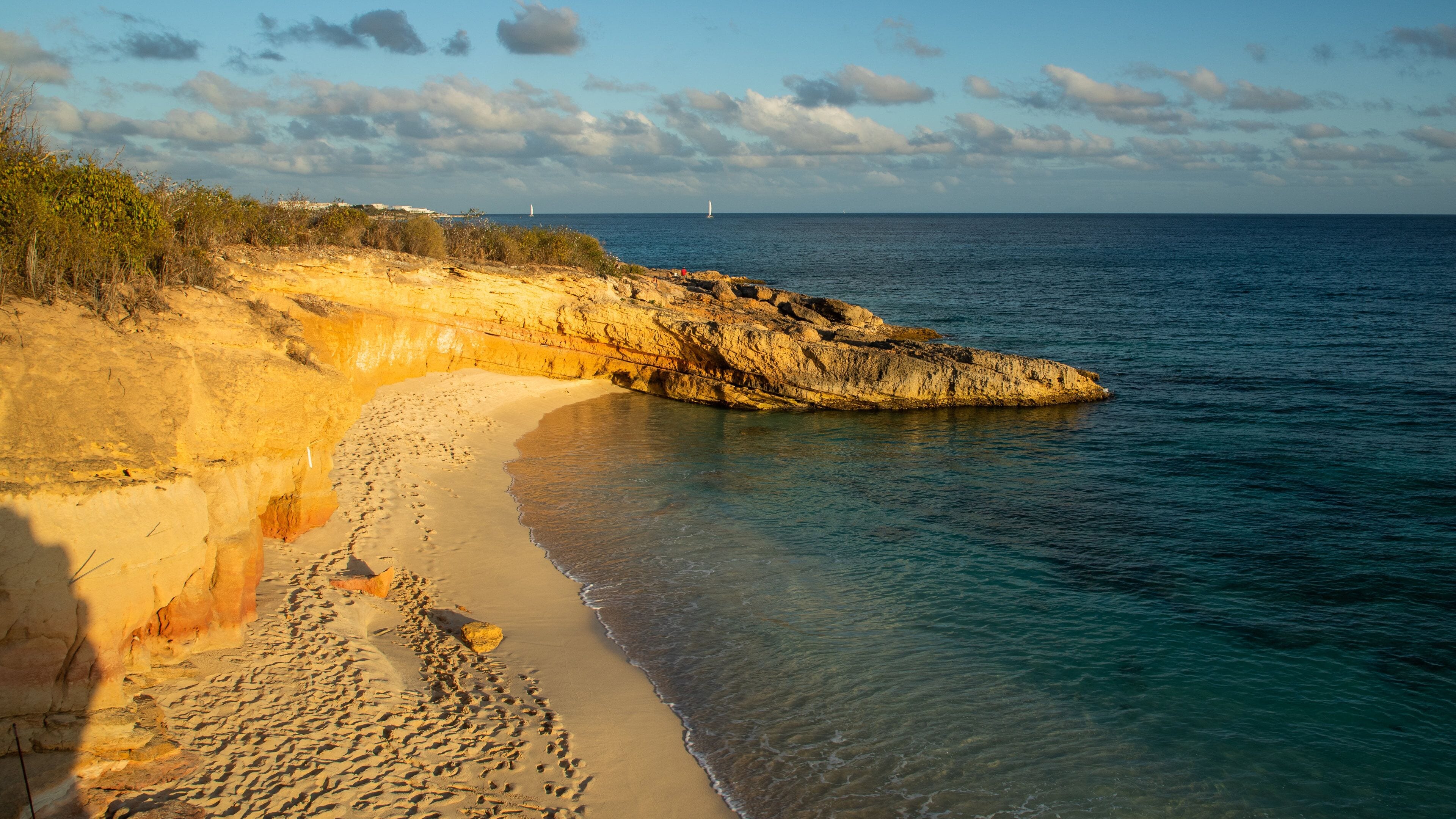 Cupecoy showing a sandy beach, rocky coastline and general coastal views