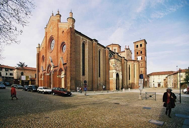 A historic church with a prominent bell tower and arched windows.