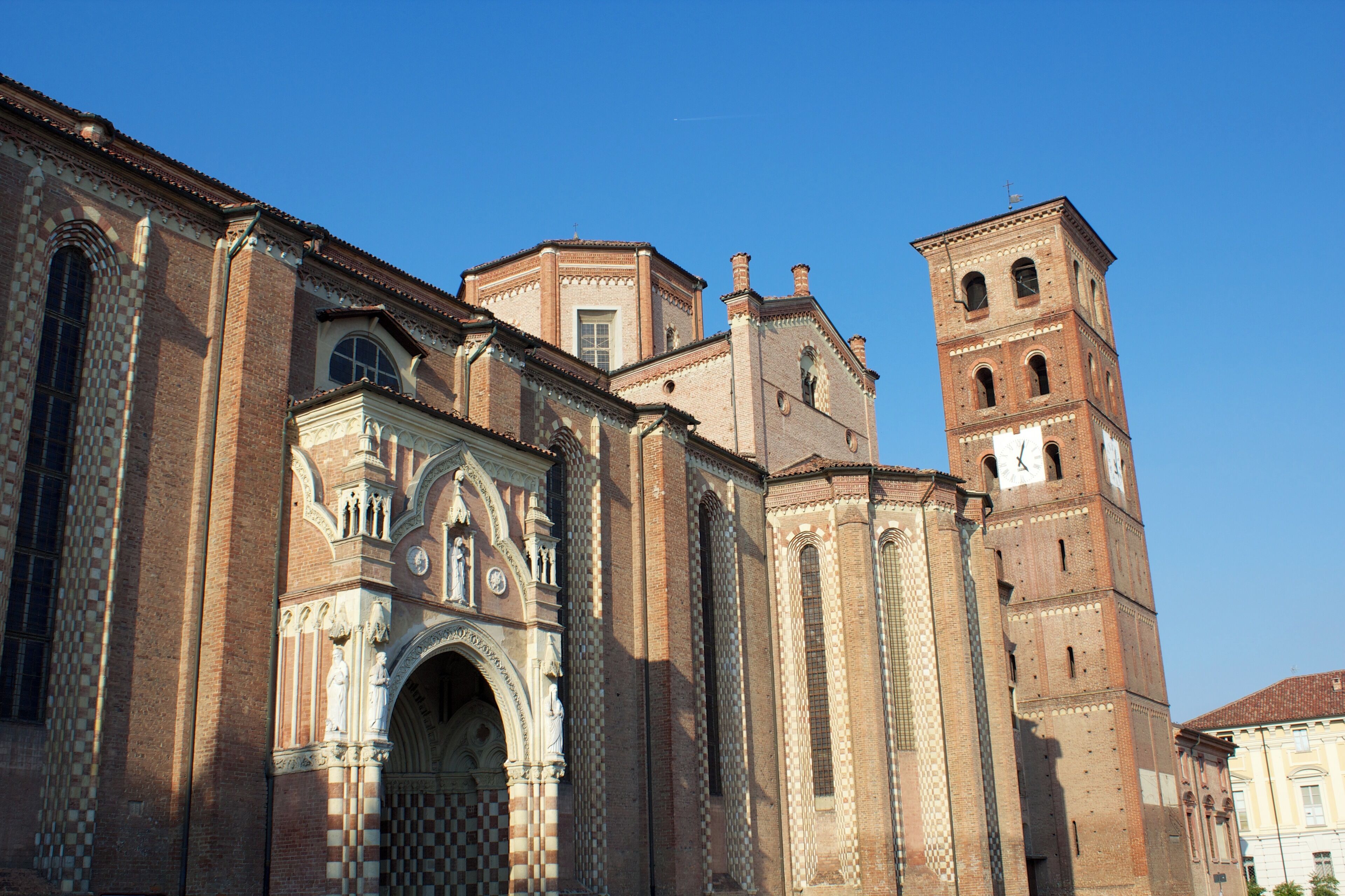 A historic church with intricate brickwork and a prominent bell tower.