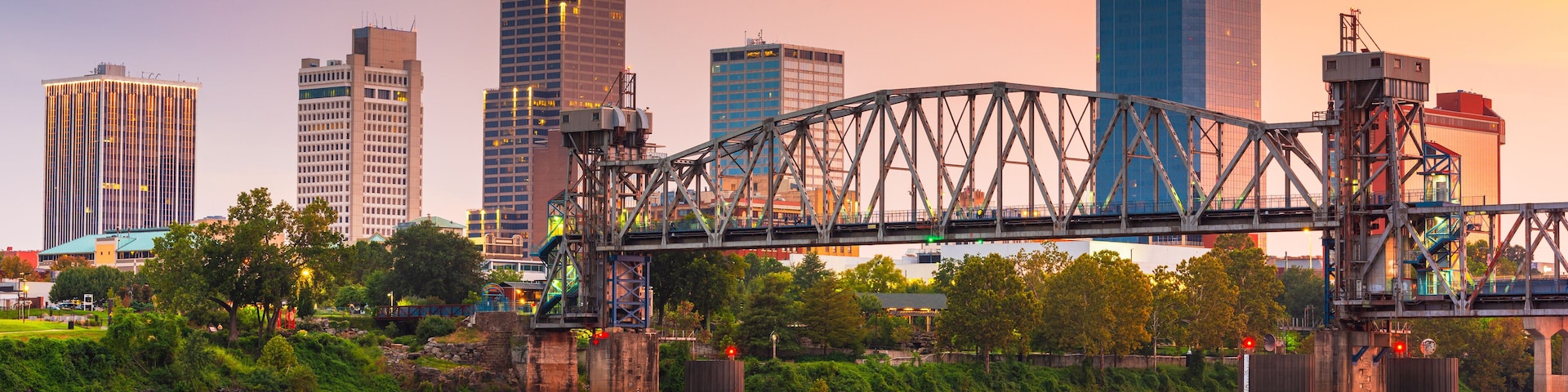 A city skyline with a prominent bridge spanning a river.