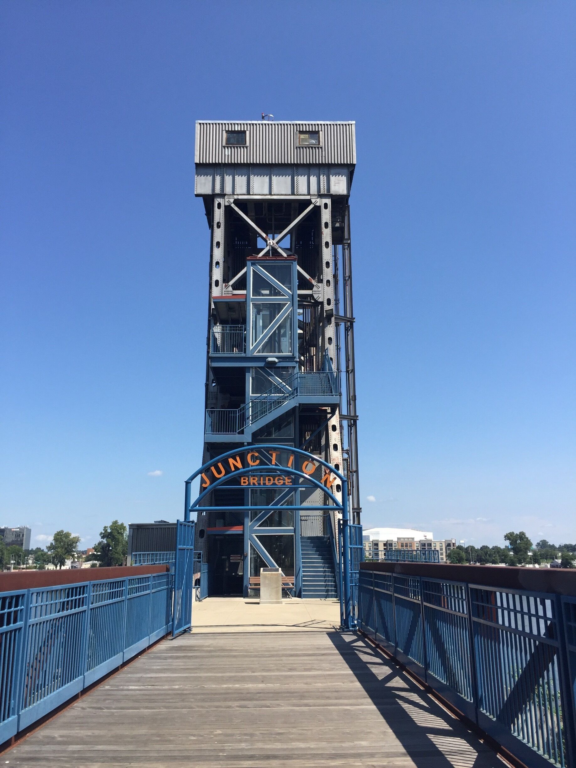 A blue metal bridge with a sign reading "JUNCTION BRIDGE".