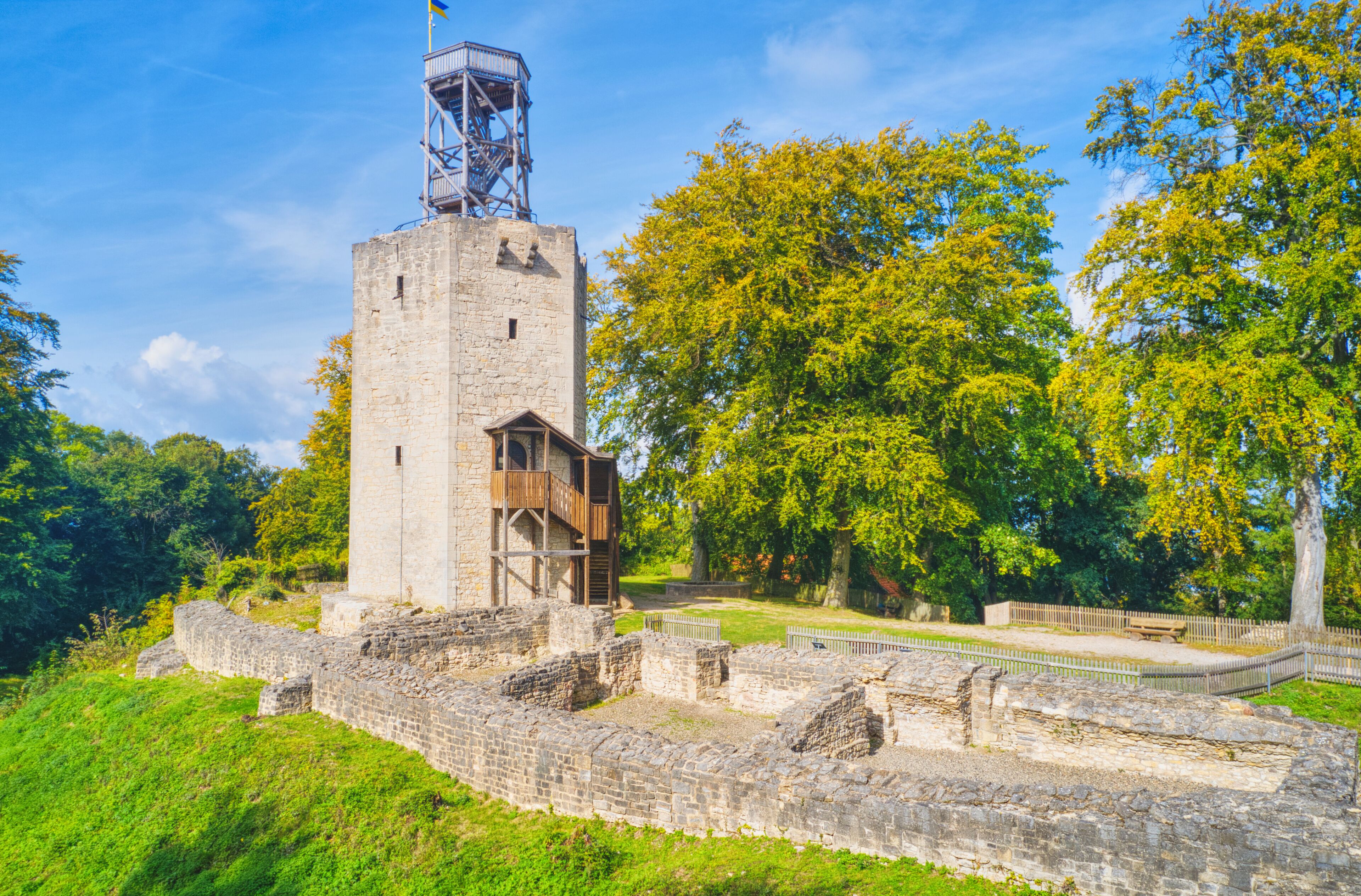 More than 1000 years old castle ruins with destroyed walls and a wooden viewing platform