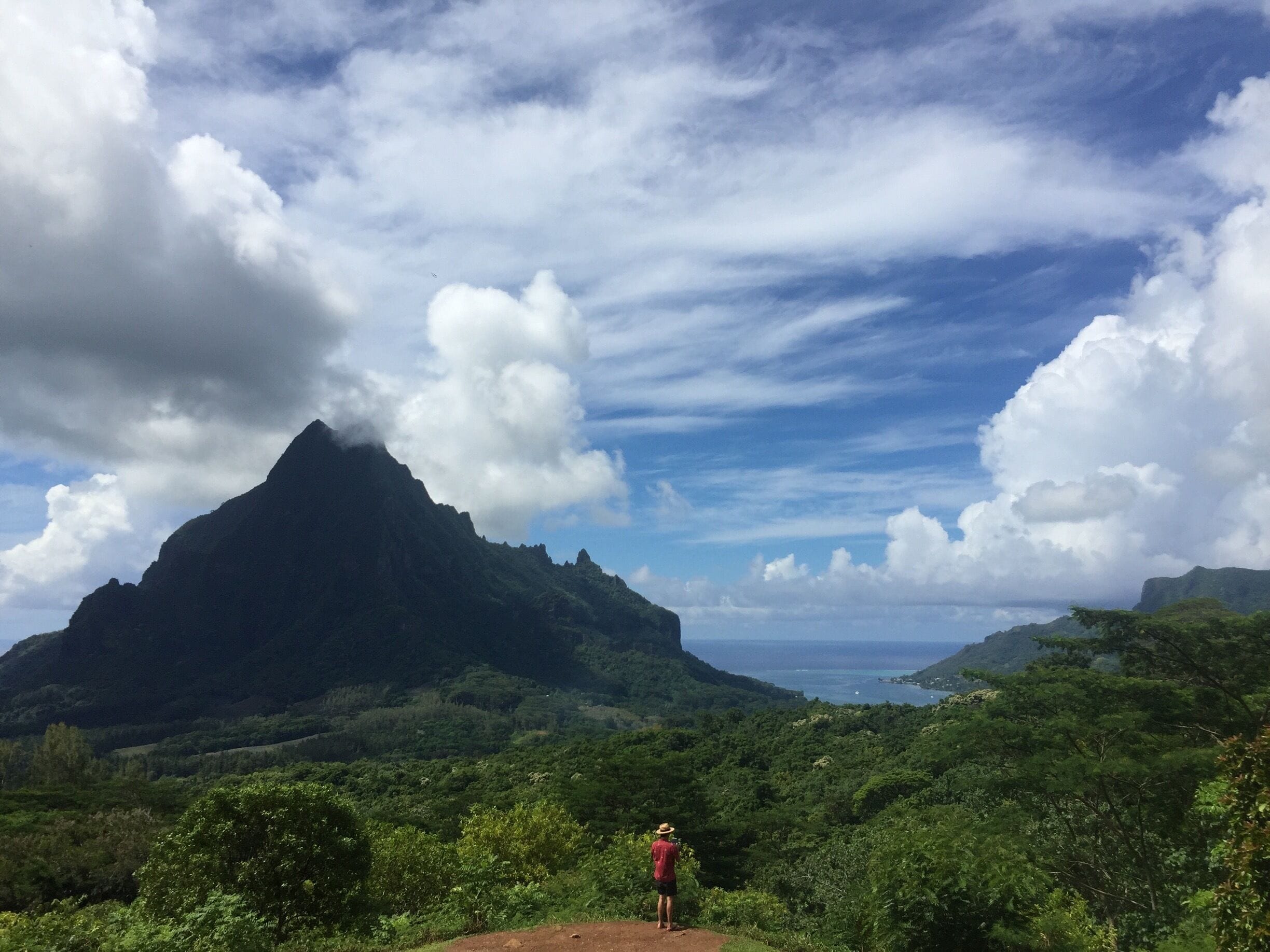 A mountainous landscape with lush greenery and a clear sky.