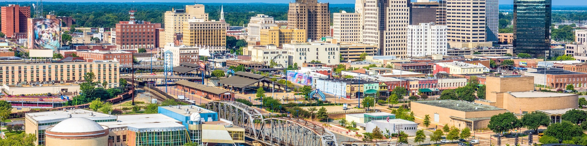 A cityscape with a prominent bridge, various buildings, and a river.