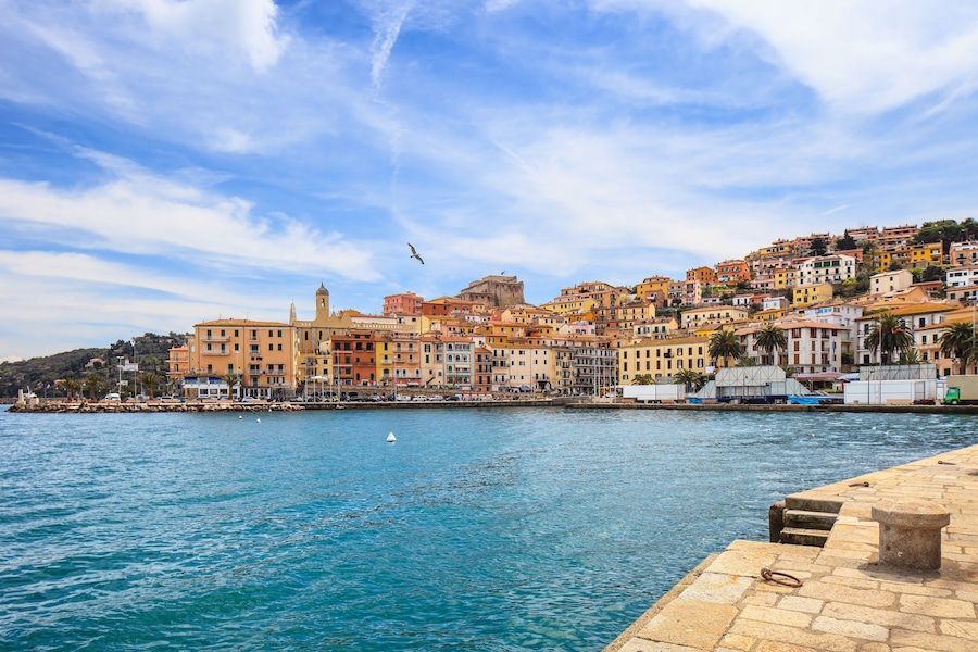 Porto Santo Stefano harbor seafront, bolllard and village skyline., italian travel destination. Monte Argentario, Tuscany, Italy., Shutterstock ID 134752493, Purchase Order: -